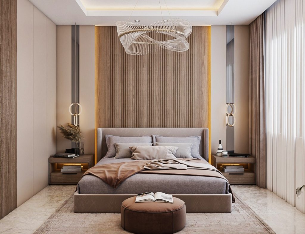 Dormitorio moderno con cama grande, mesitas de noche, un puf con un libro y una lámpara de diseño colgada del techo