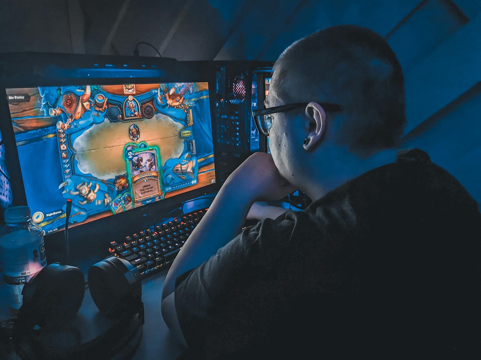 Competidores de esports en escenario con pantallas y luz de torneo profesional